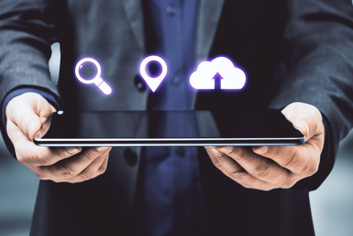 Person holding a tablet showing internet search icons